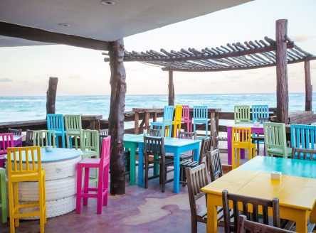 Bright colored bar-restaurant on the white sandy beach in Tulum